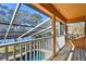 Balcony view showcasing the pool and lake, enclosed by a screen for bug-free enjoyment at 2024 Capri Ln, Mount Dora, FL 32757