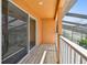 Relax on the 2nd floor outdoor balcony with wood decking and view of the lanai at 2024 Capri Ln, Mount Dora, FL 32757
