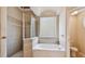 Bright bathroom featuring a large tub, tiled shower with glass doors, and a window for natural light at 2024 Capri Ln, Mount Dora, FL 32757