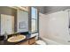 Bathroom with granite countertop, white bathtub, and overhead shower at 2024 Capri Ln, Mount Dora, FL 32757