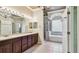 A bright bathroom features a double sink vanity, garden tub, and walk-in shower at 2024 Capri Ln, Mount Dora, FL 32757