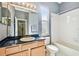 Bathroom featuring tile tub and shower combo, vanity, and natural light at 2024 Capri Ln, Mount Dora, FL 32757