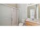 Bathroom features a tiled walk-in shower with glass doors and a vanity with a sink at 2024 Capri Ln, Mount Dora, FL 32757