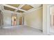 An elegant bedroom with neutral walls, decorative tray ceiling, plush carpeting and multiple closets at 2024 Capri Ln, Mount Dora, FL 32757