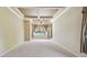 Spacious bedroom with carpet floors and a window with curtains at 2024 Capri Ln, Mount Dora, FL 32757