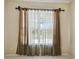 Bedroom with a window with decorative curtains that offer natural light at 2024 Capri Ln, Mount Dora, FL 32757