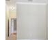 Neutral-toned bedroom with doorway leading to additional rooms and an electrical outlet at 2024 Capri Ln, Mount Dora, FL 32757