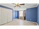 A well-lit bedroom with a ceiling fan, window, closet and hardwood flooring at 2024 Capri Ln, Mount Dora, FL 32757