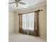 Well-lit bedroom featuring crown molding, ceiling fan, and a window with decorative curtains at 2024 Capri Ln, Mount Dora, FL 32757
