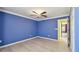 A blue bedroom offers a ceiling fan, closet and hardwood flooring at 2024 Capri Ln, Mount Dora, FL 32757