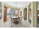 Dining area with lake view, stylish chandelier, and seating for four at 2024 Capri Ln, Mount Dora, FL 32757