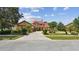Charming two-story home boasts a manicured front lawn, mature trees, and a spacious driveway at 2024 Capri Ln, Mount Dora, FL 32757