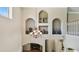 A grand foyer with high ceilings, decorative niches, and an elegant chandelier at 2024 Capri Ln, Mount Dora, FL 32757