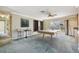 This large game room features a pool table, small wet bar, and door leading to the screened porch at 2024 Capri Ln, Mount Dora, FL 32757