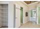 Hallway with tile floors, closet with shelving, and views into other rooms at 2024 Capri Ln, Mount Dora, FL 32757
