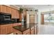 Spacious kitchen featuring granite countertops, an island, and stainless steel appliances at 2024 Capri Ln, Mount Dora, FL 32757