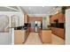 Open kitchen with island, stainless appliances, and tile flooring at 2024 Capri Ln, Mount Dora, FL 32757