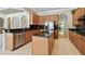 Bright kitchen with dark granite countertops, stainless appliances, and center island at 2024 Capri Ln, Mount Dora, FL 32757