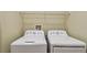 Bright laundry room featuring modern, white, front-loading washing and drying machines at 2024 Capri Ln, Mount Dora, FL 32757