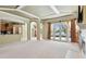 Spacious living room with a fireplace, built-in shelving, and French doors leading to an outdoor living space and pool at 2024 Capri Ln, Mount Dora, FL 32757