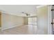 Open-concept living room with hardwood flooring, sliding glass doors, and a ceiling fan at 2024 Capri Ln, Mount Dora, FL 32757