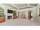 Cozy living room with a fireplace, built-in shelving, archways, and a view of the staircase at 2024 Capri Ln, Mount Dora, FL 32757
