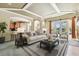 Bright living room showcasing neutral decor, archways, and views of the outdoor area with a pool at 2024 Capri Ln, Mount Dora, FL 32757