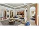 Cozy living area with archways, coffered ceilings, and an adjacent kitchen and dining area at 2024 Capri Ln, Mount Dora, FL 32757