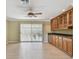 Spacious living room featuring hardwood flooring, bar with cabinets, and sliding doors to the lanai at 2024 Capri Ln, Mount Dora, FL 32757