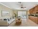 Inviting living room featuring stylish furniture, a ceiling fan, and a sliding glass door with backyard views at 2024 Capri Ln, Mount Dora, FL 32757