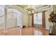 Inviting living room with a chandelier, large windows, and an entrance leading to a staircase and front door at 2024 Capri Ln, Mount Dora, FL 32757