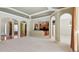 Open-concept layout showing living space with coffered ceilings, archways, and views of the kitchen at 2024 Capri Ln, Mount Dora, FL 32757