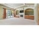 Bright living area features an entertainment center, fireplace, and French doors to the outdoors at 2024 Capri Ln, Mount Dora, FL 32757