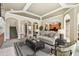 Comfortable living room featuring neutral furniture, archways leading to other rooms, and a view of the kitchen at 2024 Capri Ln, Mount Dora, FL 32757