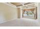 Spacious main bedroom with large windows overlooking the backyard and a decorative tray ceiling at 2024 Capri Ln, Mount Dora, FL 32757