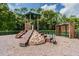 Community playground with climbing structure, slide, and covered bench area at 2024 Capri Ln, Mount Dora, FL 32757