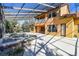 Back of the house with an enclosed pool area, offering an outdoor space for relaxation and enjoyment at 2024 Capri Ln, Mount Dora, FL 32757