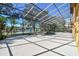 Spacious enclosed pool area with a lake view, providing privacy and room for entertaining at 2024 Capri Ln, Mount Dora, FL 32757