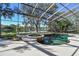 Enclosed pool and spa overlooking a serene lake at 2024 Capri Ln, Mount Dora, FL 32757