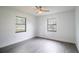 Bedroom featuring a ceiling fan and two windows providing natural light at 7631 Lewis Rd, Lakeland, FL 33810