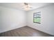 Bright bedroom with vinyl plank flooring and a large window at 7631 Lewis Rd, Lakeland, FL 33810