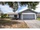 Newly renovated single story home with gray accents and a two-car garage at 7631 Lewis Rd, Lakeland, FL 33810