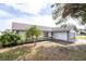 Single-story home with gray accents and palm trees at 7631 Lewis Rd, Lakeland, FL 33810