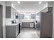 Modern kitchen featuring gray cabinets, stainless steel appliances, and a marble backsplash at 7631 Lewis Rd, Lakeland, FL 33810