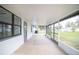 Enclosed porch with tile flooring and screens, offering a relaxing outdoor space at 7631 Lewis Rd, Lakeland, FL 33810