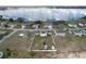 Aerial view of the property, a single Gathering home with a fenced backyard near a lake at 169 Vista View Ave, Eagle Lake, FL 33839