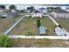 Aerial view of the backyard, featuring an enclosed fence, chicken coop, and verdant greenery at 169 Vista View Ave, Eagle Lake, FL 33839