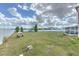 Backyard featuring a large grassy area, a screened-in porch, and a white fence for added privacy at 169 Vista View Ave, Eagle Lake, FL 33839