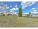 Backyard featuring a tall evergreen tree and a chicken coop, with a partially visible fence at 169 Vista View Ave, Eagle Lake, FL 33839
