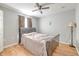 Bedroom with light wood floors, gray walls, and a ceiling fan overhead at 169 Vista View Ave, Eagle Lake, FL 33839